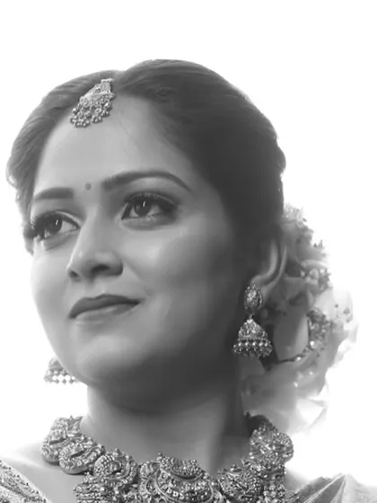 A classic black and white close-up of a bride, highlighting her traditional jewelry and serene expression. This timeless style emphasizes emotion and beauty.