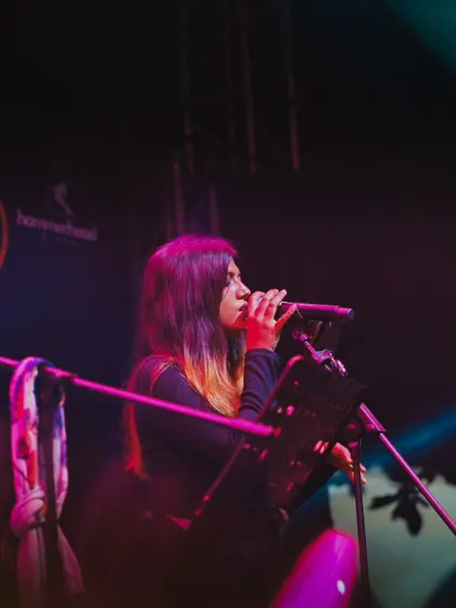 My talented vocalist, lost in the melody during our show at The Night Market. Each member of the band brings their own unique soul to the performance.