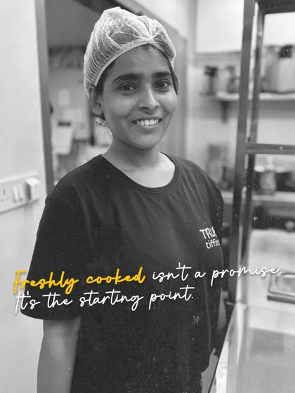 Freshly cooked isn't a promise, it's the starting point. My chefs, like this smiling team member, prepare everything from scratch each morning.