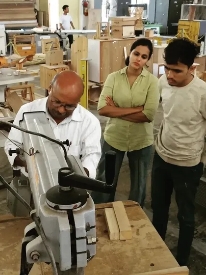 An instructor explains the functionality of a radial arm saw. Students learn to make precise crosscuts and angled cuts on this versatile machine.