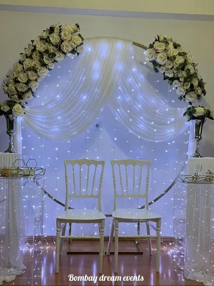 Another view of the classic white anniversary decor. The soft lighting from the fairy lights and candles creates a warm and romantic ambiance, perfect for an intimate celebration at home.