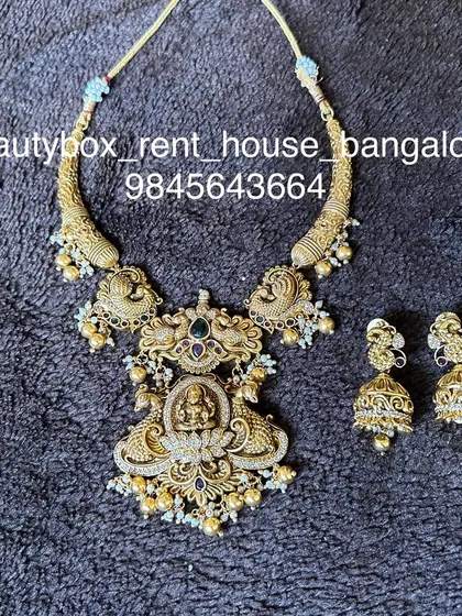 A statement antique pendant necklace with a large Lakshmi motif. This piece is heavy and perfect for making an impact at your event.