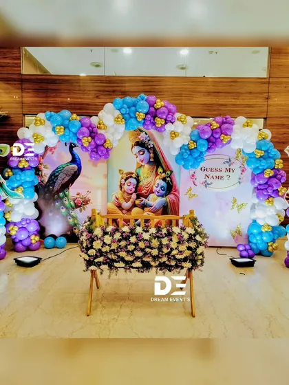 We love bringing fun themes to traditional events. This Little Krishna themed naming ceremony decor combines a divine backdrop with playful balloon arches in shades of blue and purple, creating a joyful atmosphere for the whole family.