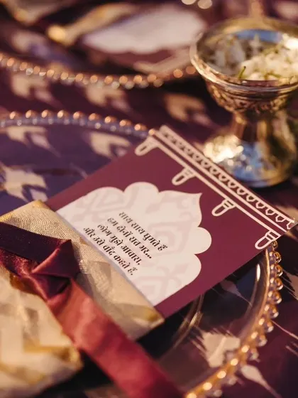 A personalized welcome note and a small pouch of favors (potli) placed on each guest's plate, a thoughtful gesture to make everyone feel special from the very first event.