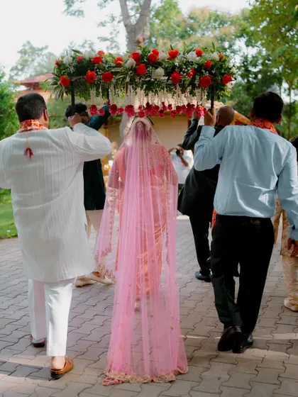 The bride's entry under a beautiful phoolon ki chadar. A classic and elegant moment from Tania and Vinod's North Indian wedding ceremony.