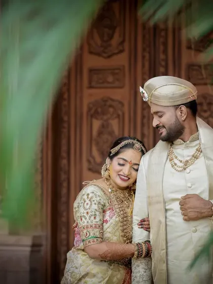 A quiet, romantic portrait of the couple framed by lush greenery. We find serene spots even amidst a busy wedding day to capture these peaceful moments.