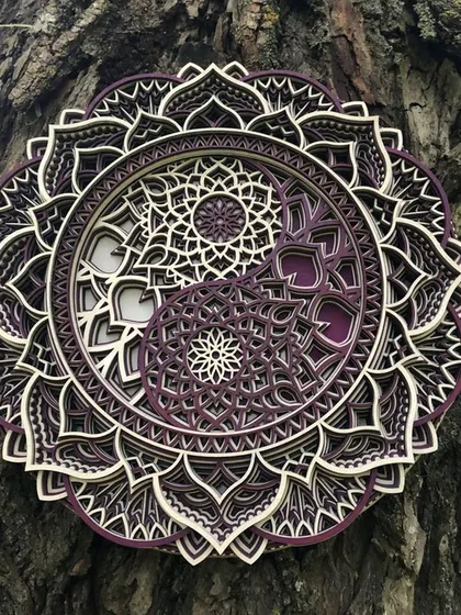 Our Yin Yang mandala is shown here in a custom purple and white finish, displayed in a natural outdoor setting to showcase its versatility. All our art can be customized in the color of your choice.