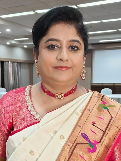 A close-up of the mother of the bride, looking radiant for the haldi ceremony. The makeup is fresh and minimal, perfect for a daytime event, paired with a simple, elegant hairstyle.