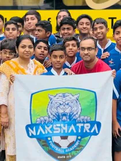 A close-up of our players and their families, holding the Nakshatra FC banner with pride before heading to the tournament in Ahmedabad.