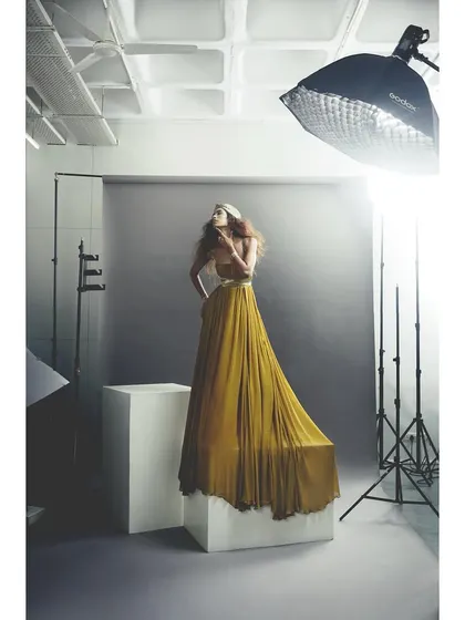 Another angle from the studio, showing the model in a vibrant yellow dress. This demonstrates how we can create entirely different moods within the same lighting setup.