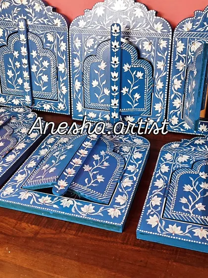 Inspired by the ornate windows of Rajasthani palaces, I hand-paint these wooden Jharokha frames. This collection shows the variety of designs available, each featuring delicate floral patterns and some with mirrors, adding a touch of royal elegance to your wall decor.