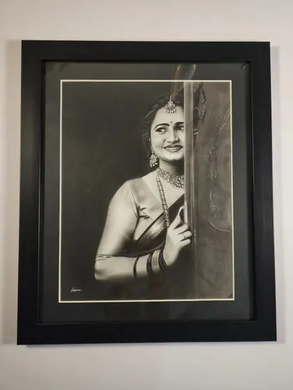 The finished traditional portrait in a black frame with a white mount, creating a classic and elegant presentation.