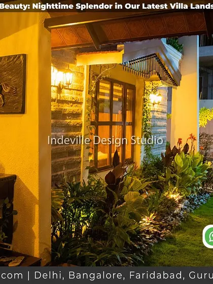 An indoor-outdoor space at night. The lighting connects the interior desk area with the garden just outside, creating a seamless transition.