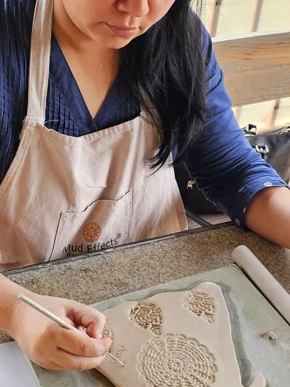 A few snapshots of corporate team members completely absorbed in their creative process. They are making everything from decorative nameplates to unique bowls during our hand-building workshop.