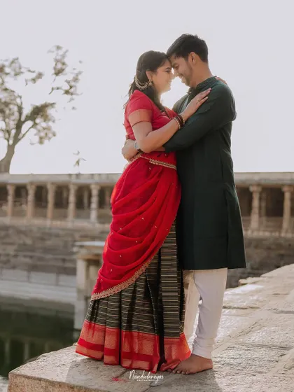 An intimate embrace by the temple pond, the soft light creating a serene and romantic atmosphere.