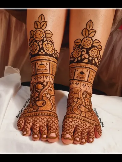 A traditional bridal feet design featuring peacocks and jhumkas. The rich, dense pattern is perfect for a bride who wants a classic look.