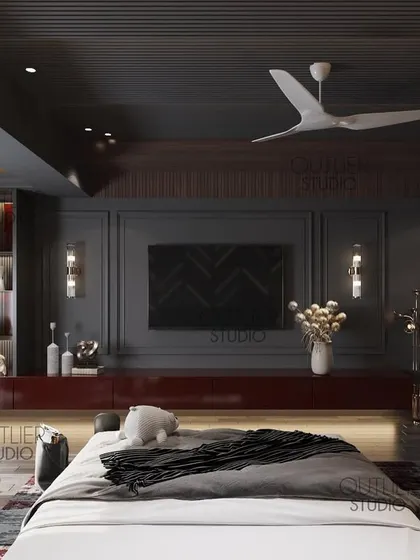 Dark aesthetics define this bedroom. The design uses a dark color palette, a bold red media console, and dramatic lighting to create a space that is moody, modern, and luxurious.