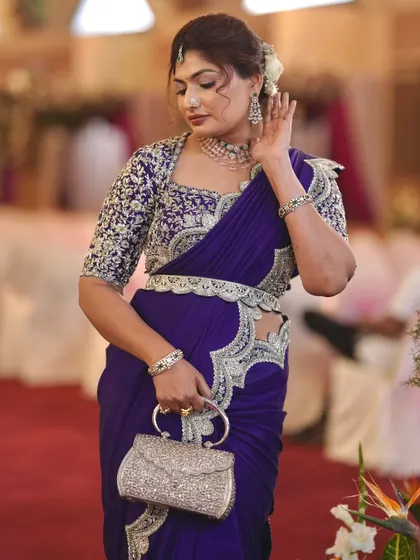 A full-length shot showing the complete reception look, including the stylish saree draping and accessories.