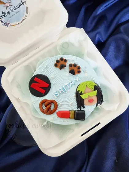 A bento cake for the ultimate cool girl. This one is customized with her favorite things: Netflix, lipstick, a pretzel, and a nod to Billie Eilish.