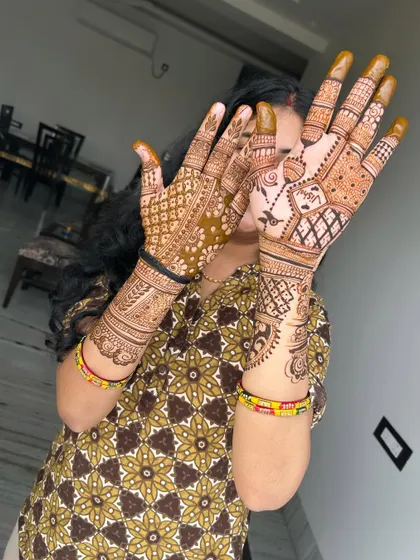 A happy client showing off her full Karwachauth mehndi. Seeing the joy my art brings is the ultimate reward.