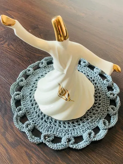 For a more classic and elegant look, I designed this intricate grey lacy doily. It’s perfect for placing under a special showpiece, like this whirling dervish statue, to give it a beautiful, handcrafted base.