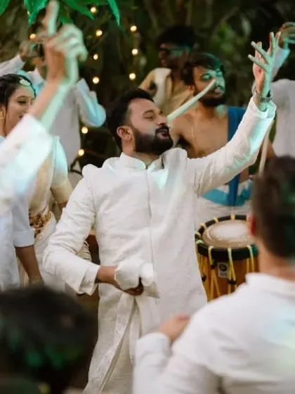 The groom and guests dancing with abandon to the beats of a traditional chenda melam.