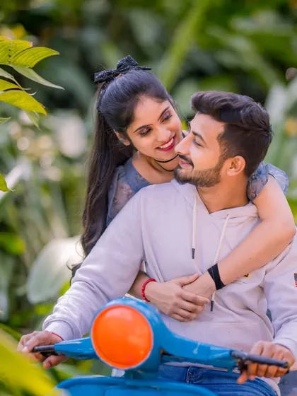 A cute and romantic moment on a scooter, surrounded by lush greenery. This shot is perfect for capturing the fun and carefree spirit of a couple's love story.