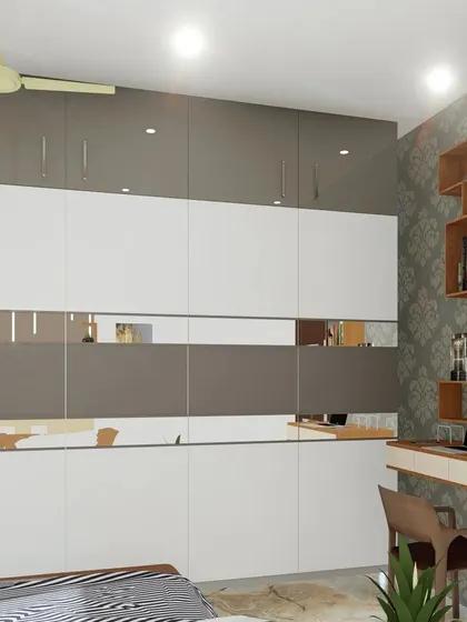 A bedroom design featuring a two-tone grey and white wardrobe with a mirrored strip. The adjacent wall has a built-in study desk and bookshelf.