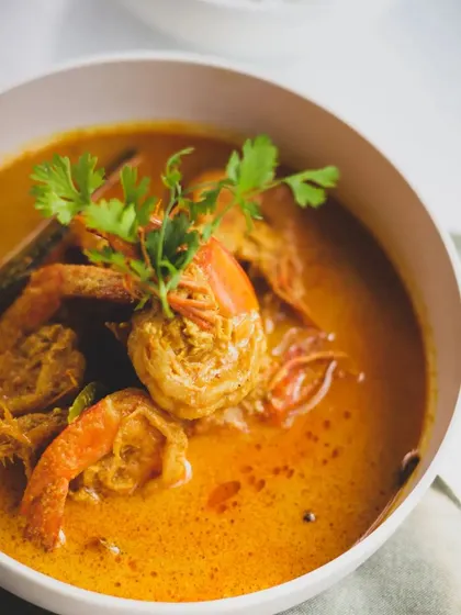 A rich and creamy prawn curry, showcasing the use of coconut milk, a staple in many coastal Indian kitchens.