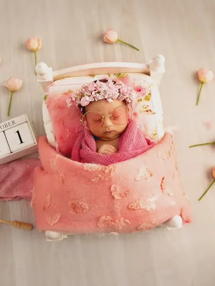 This whimsical setup tells a story, complete with a date block, a tiny parasol, and butterflies. It's a perfect example of a personalized, prop-heavy theme to celebrate a birth date.