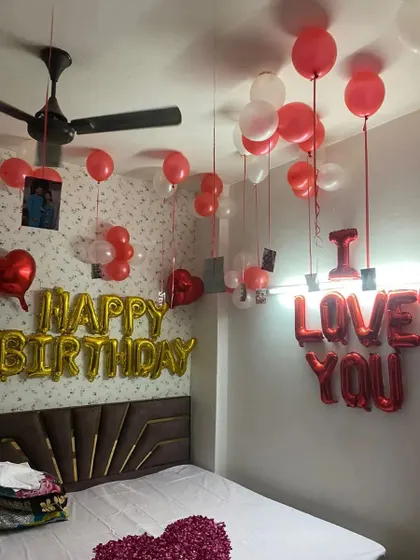 Make their birthday both romantic and personal. This room decoration combines 'Happy Birthday' and 'I Love You' messages, and I add a special touch by hanging 15-16 of your personal photos from the balloons, telling your unique story.