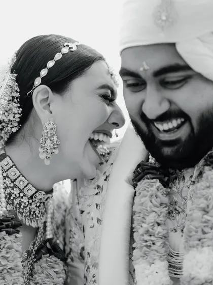The unrestrained laughter of a bride and groom. This black and white photo of Disha and Herin is a perfect example of the real, candid moments that we believe are the heart of any wedding.