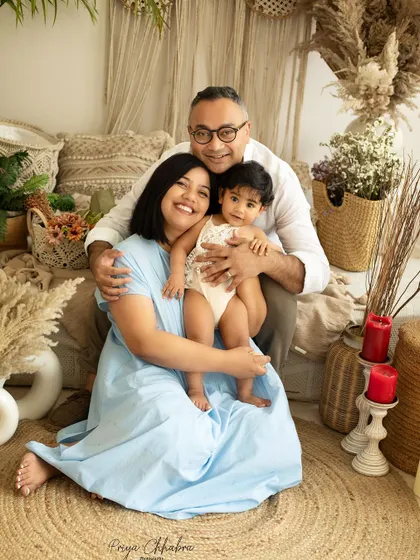 A perfect family portrait. This photo captures the joy and love of this family of three in a relaxed, cozy studio setting.