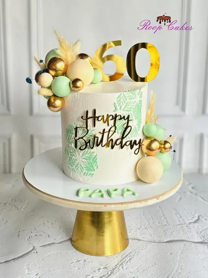 A grand celebration for a grand milestone. This elegant 60th birthday cake for 'Papa' features modern green stenciling and golden sphere accents.