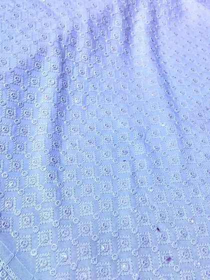 A classic light blue Chikankari material with delicate white embroidery. This fabric makes for a sophisticated and comfortable kurta suitable for any traditional gathering.