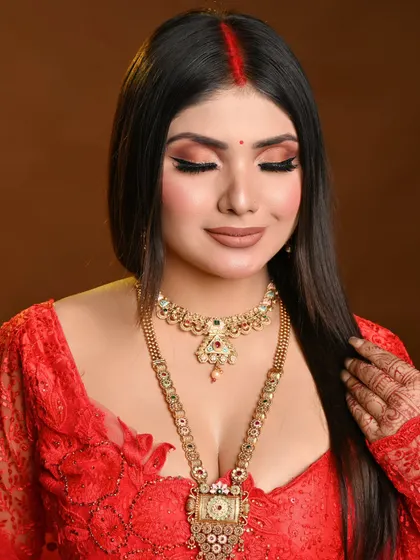 A soft, romantic pose that still showcases the beautiful makeup. The focus is on glowing skin and expressive eyes.