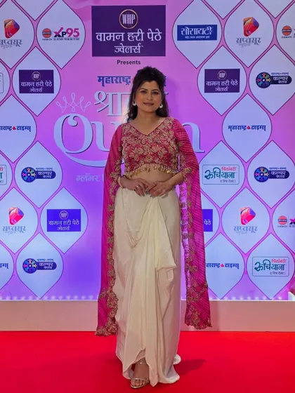 A full-length view of Savaniee's stylish indo-western outfit. The makeup and hair are designed to be modern and chic for the event.