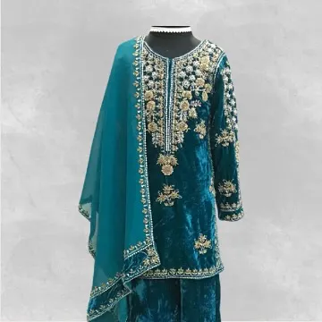 A luxurious teal velvet suit, custom-made for a winter wedding. The kurta is adorned with intricate gold and silver hand embroidery.