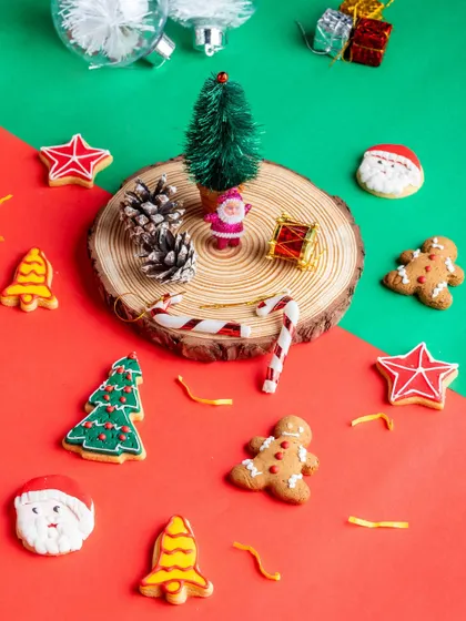 Our assorted Christmas cookies are a festive delight. This flat-lay shows the variety of shapes, including Santa, gingerbread men, stars, bells, and trees, all intricately decorated.