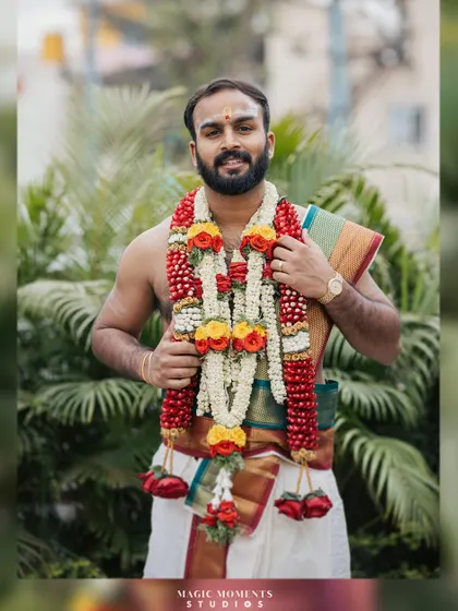 A handsome portrait of the groom, Akash, looking ready for his wedding ceremony in traditional South Indian attire.