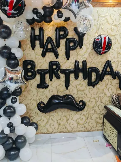 A fun and stylish "mustache" themed birthday for him. This simple yet effective wall decor uses black and white balloons and a 'Happy Birthday' foil set.