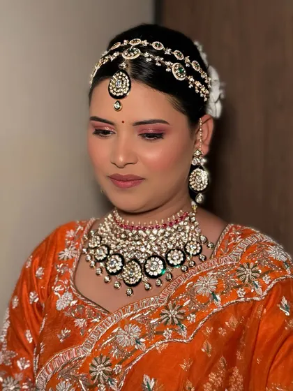 A closer view of the makeup for our bride in orange. The eye makeup features warm, shimmery tones that make her eyes pop, paired with a flawless, glowing base.