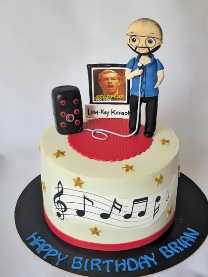A cake for a karaoke singer and Coldplay fan. The design includes a custom figurine, a karaoke speaker, and musical notes.