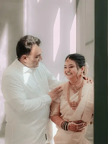 A heartwarming, candid moment between a bride and her father. The genuine laughter and affection in this photo make it a priceless memory.