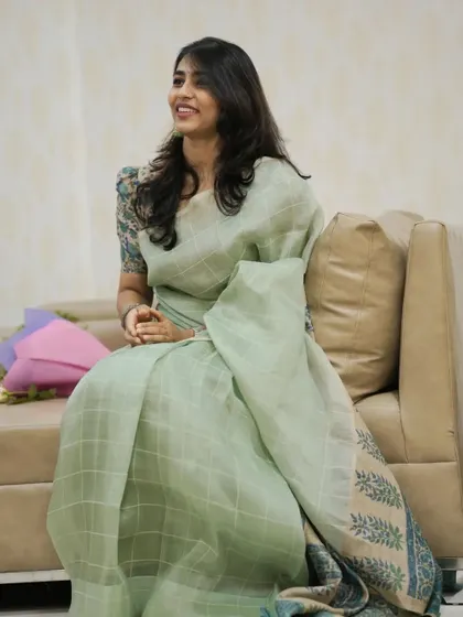 Sapthami Gowda in a serene pastel green linen saree with a custom floral print blouse.