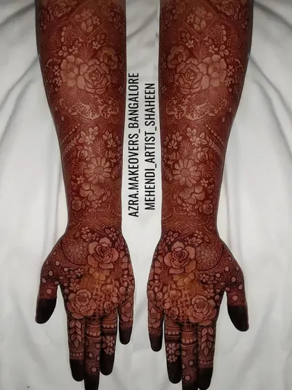 A stunning full-arm design created with the negative space technique, where the background is filled to make the flowers stand out.