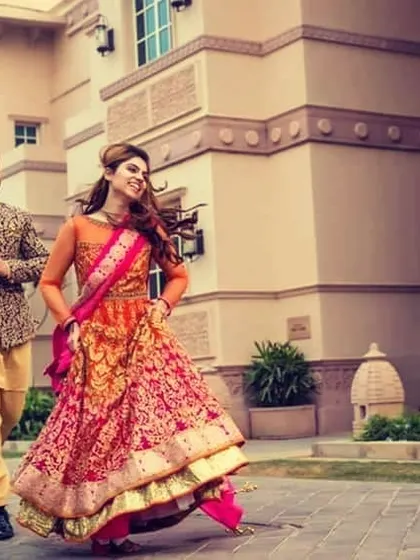 A candid and joyful moment of the couple running and laughing together during their wedding festivities.