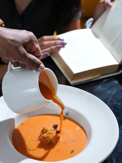 From velvety soups to bold plates, my four-course lunch is its own mood. Here, a creamy tomato soup is poured at the table.