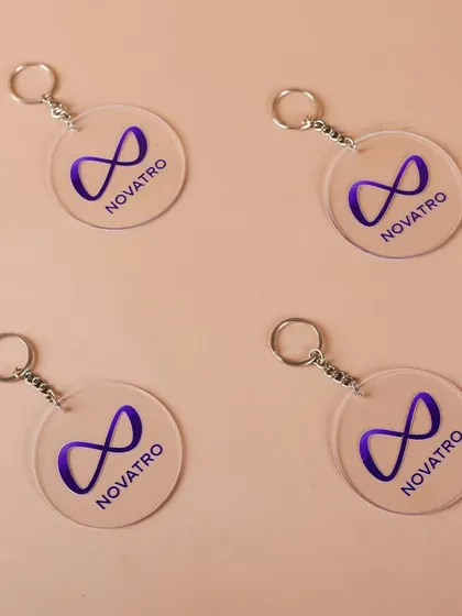 Custom acrylic keychains with the Novatro.ai logo. Small branded items like these are perfect additions to any new employee welcome basket.