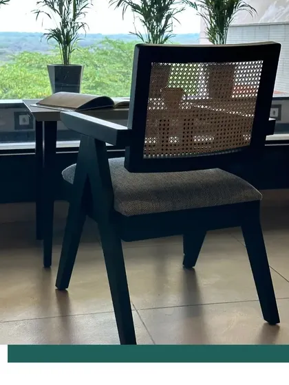 Our Chandigarh Chair, seen here against a backdrop of lush greenery, feels both classic and perfectly at home in a contemporary, biophilic setting.